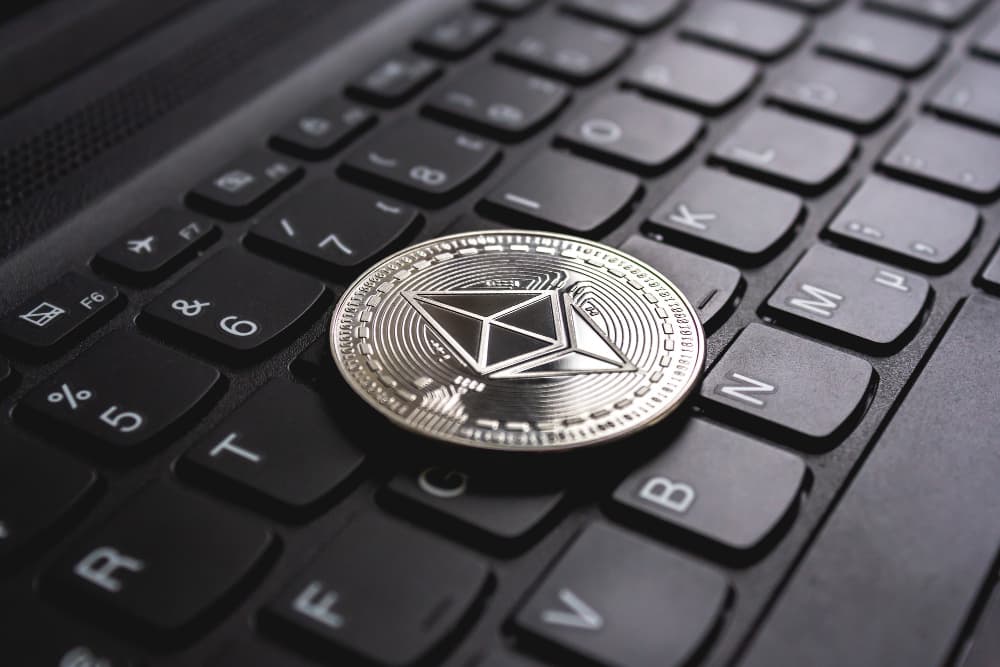 ethereum coin placed on top of a black keyboard